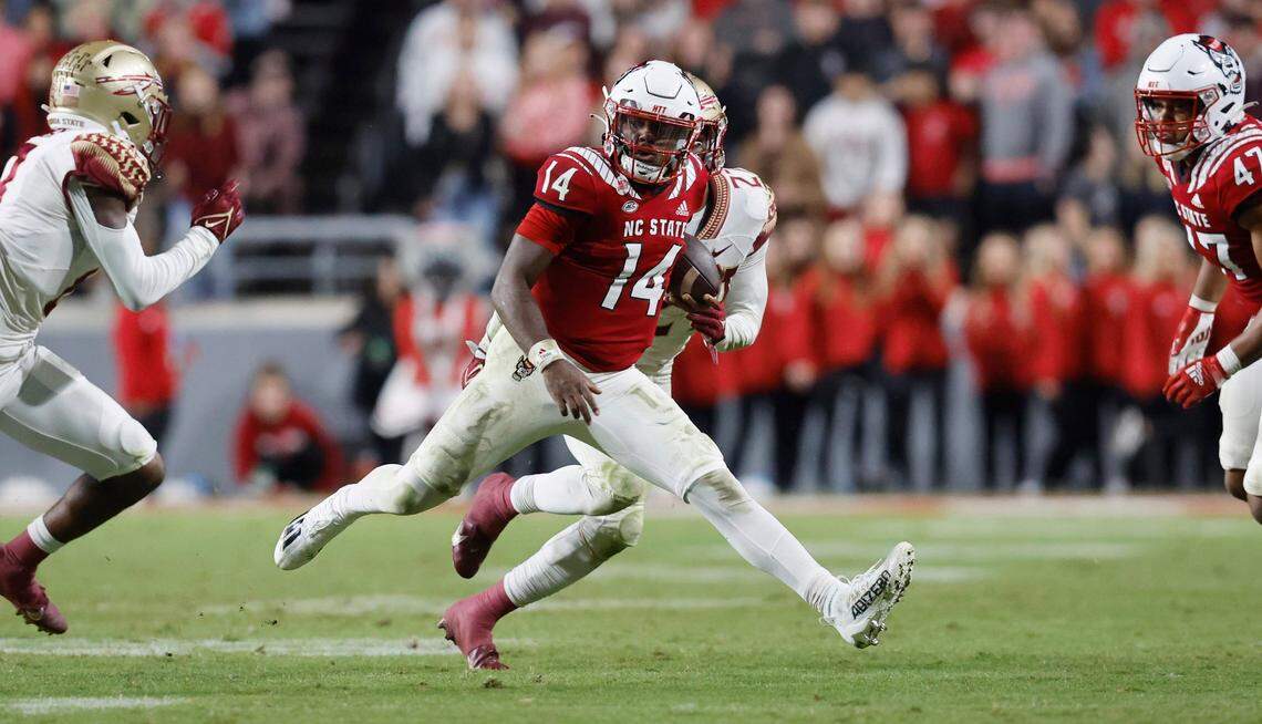 N.C. State quarterback Jack Chambers (14) gains yards during the second half of N.C. State’s 19-17 victory over Florida State at Carter-Finley Stadium in Raleigh, N.C., Saturday, Oct. 8, 2022.