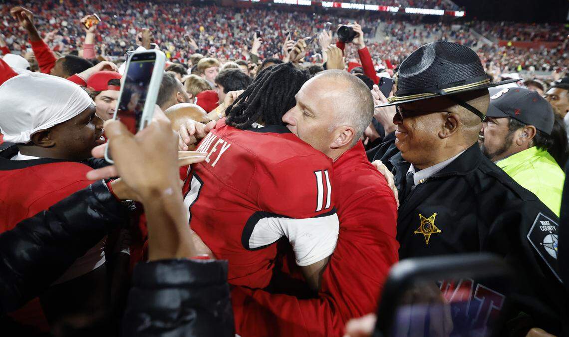 N.C. State head coach Dave Doeren hugs quarterback CJ Bailey (11) after N.C. State’s 48-36 victory over Georgia Tech at Carter-Finley Stadium in Raleigh, N.C., Saturday, Nov. 1, 2025.