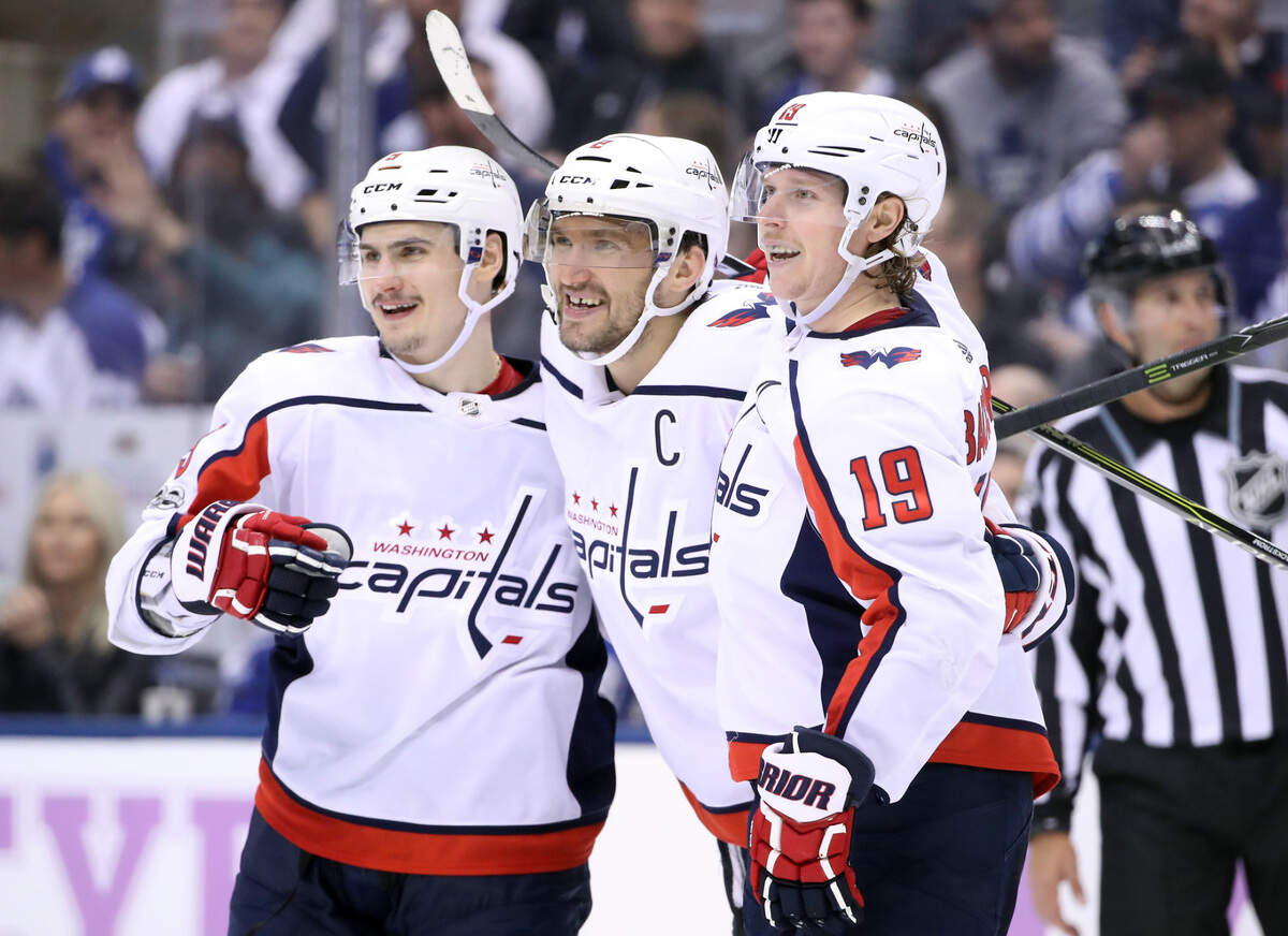 Washington Capitals left wing Alex Ovechkin (8) celebrates his hat-trick goal with defenseman Dmitry Orlov (9) and center Nicklas Backstrom (19) late in the third period against the Toronto Maple Leafs at Air Canada Centre. The Capitals beat the Maple Leafs 4-2.