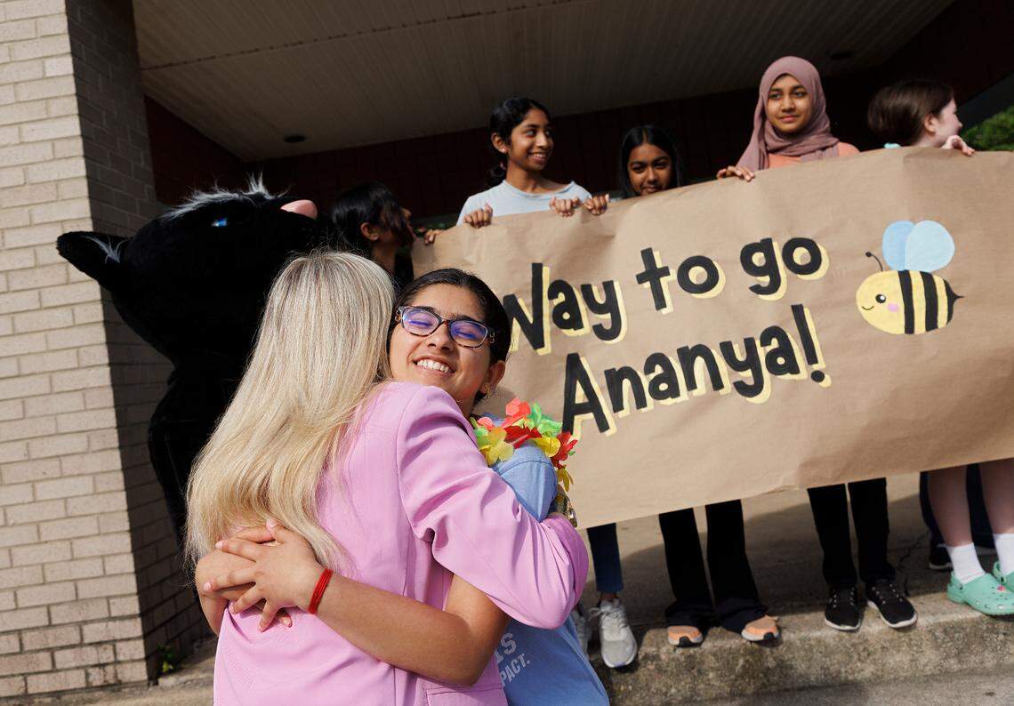 Davis Drive Middle School seventh-grader Ananya Rao Prassanna receives a hug from Assistant Principal Anna Best during a celebration on Monday, June 3, 2024, in Cary, N.C. honoring Prassanna’s third-place finish in the Scripps National Spelling Bee.