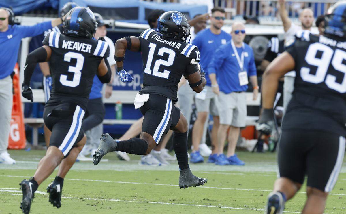 Duke linebacker Tre Freeman (12) returns an interception 67-yards during the first half of N.C. State’s game against Duke at Wallace Wade Stadium in Durham, N.C., Sat. Sept. 20, 2025