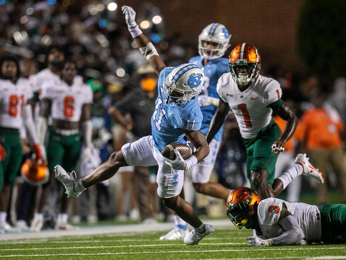 North Carolinas Josh Downs (11) breaks away from Florida A&Ms Kendall Boehler (3) for a 13-yard gain on a pass from quarterback Drake May in the first quarter on Saturday, August 27, 2022 at Kenan Stadium in Chapel Hill, N.C.