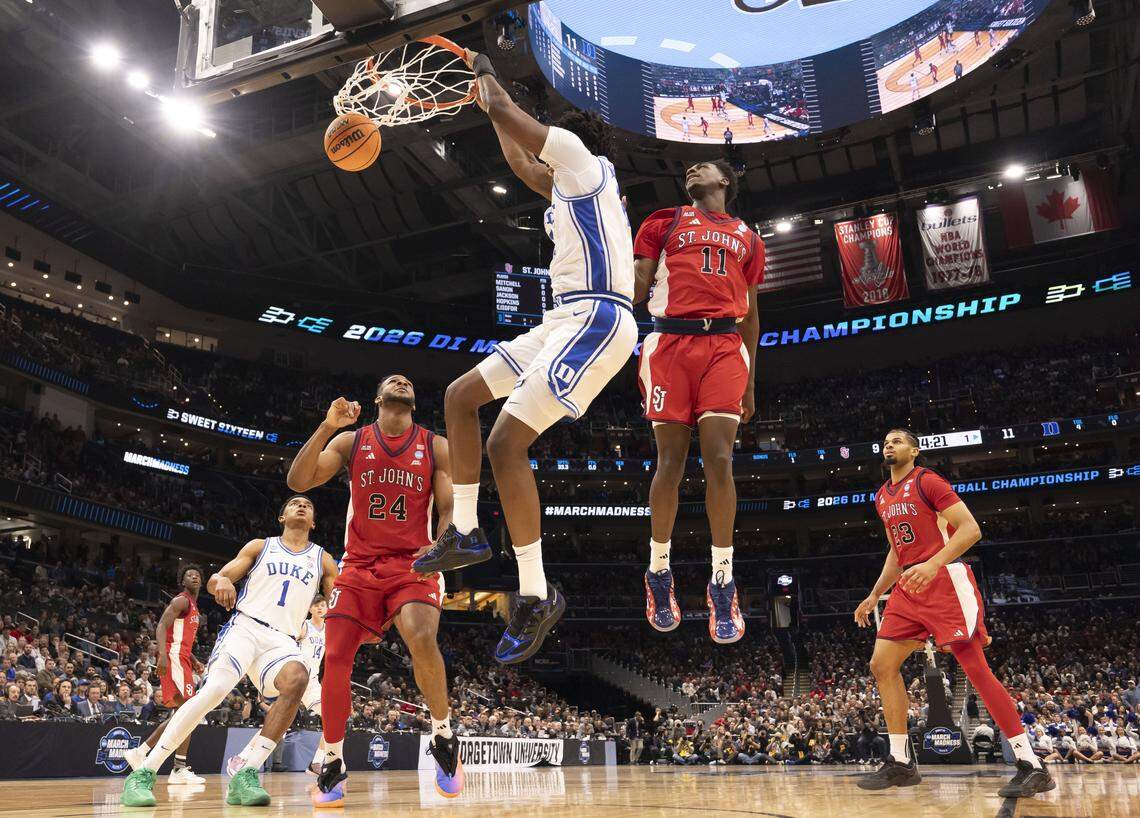 Duke center Patrick Ngongba II (21) dunks over St. John’s forward Zuby Ejiofor (24) and guard Ian Jackson (11) in the first half during the Sweet Sixteen of the NCAA Tournament on Friday, March 27, 2026, at Capital One Arena in Washington, D.C.