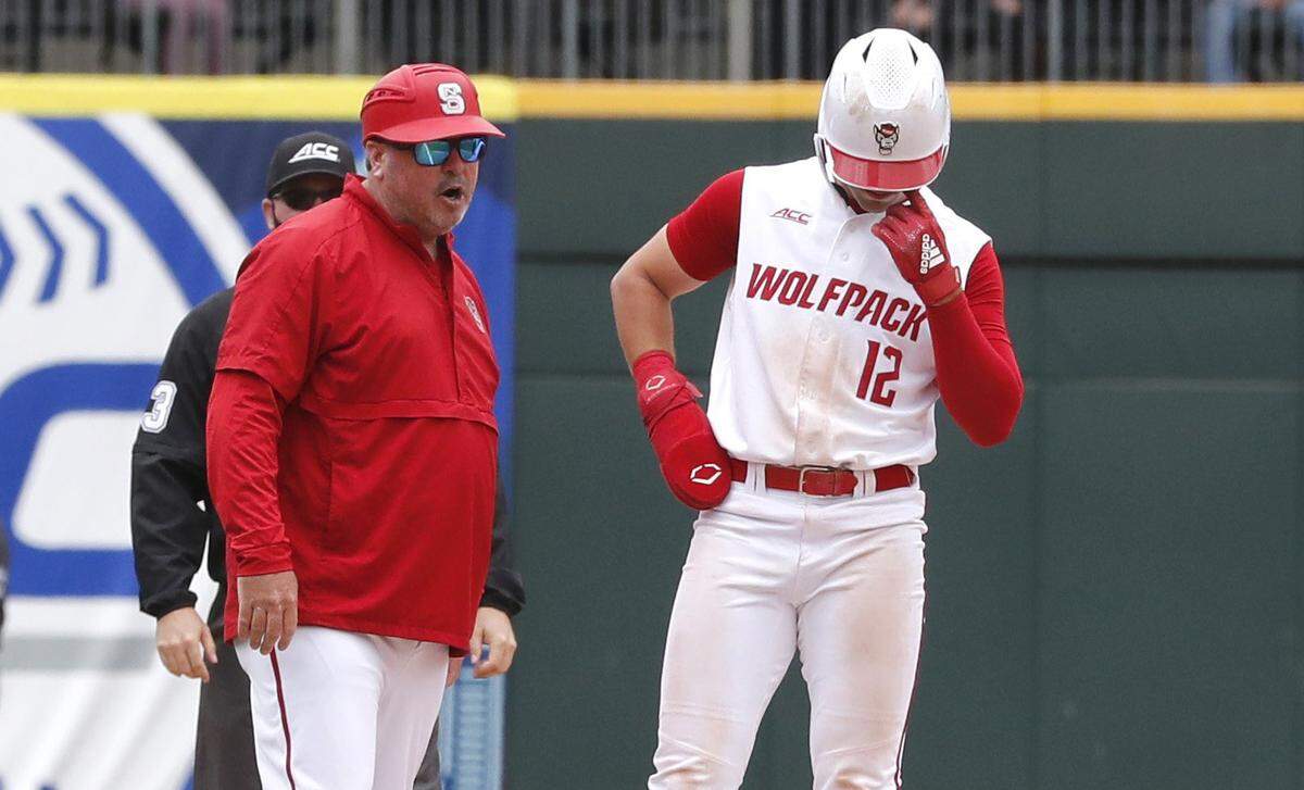 N.C. State associate head coach Chris Hart talks with Austin Murr (12) after the player didn’t tag up to home on a sacrifice fly during Duke’s 1-0 victory over N.C. State to win the ACC Baseball Championship game at Truist Field in Charlotte in 2021.