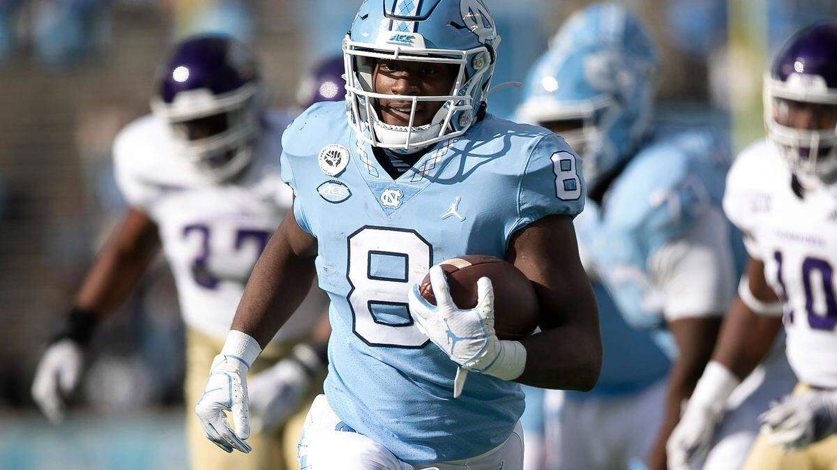 North Carolina’s Michael Carter (8) scores on a 17-yard carry to give the Tar Heels’ a 7-0 lead over Western Carolina in the first quarter on Saturday, December 5, 2020 at Kenan Stadium in Chapel Hill, N.C.