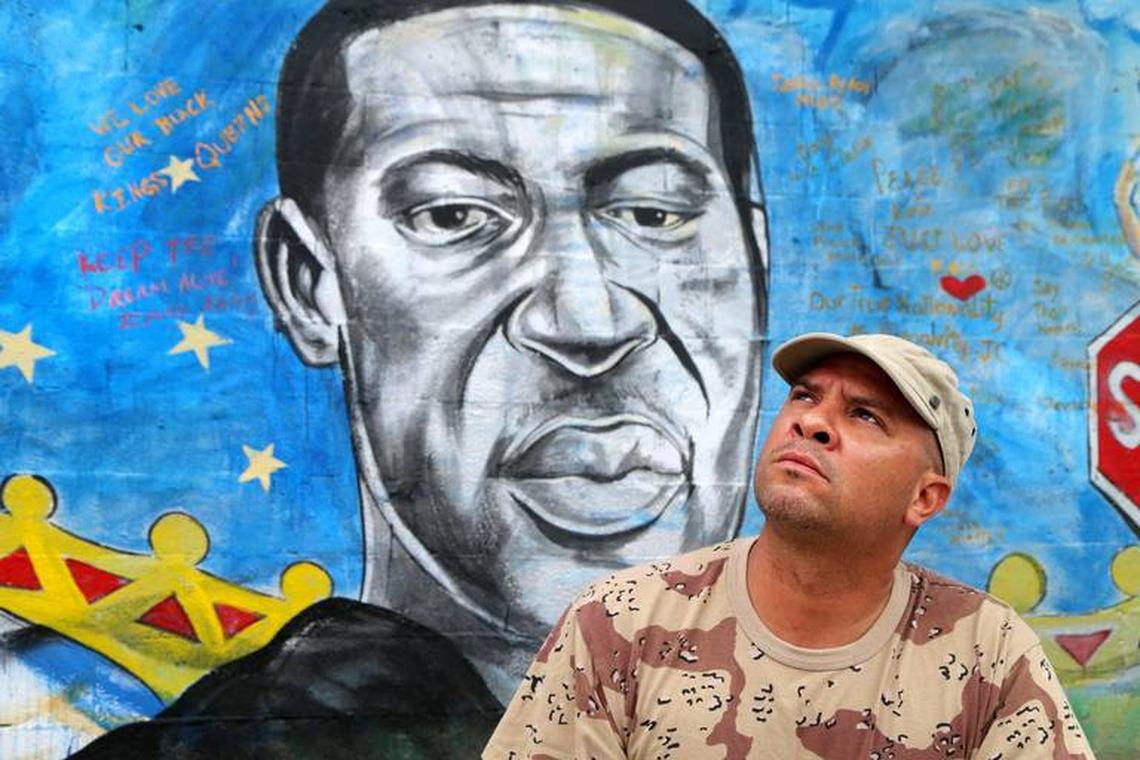 Artist Kyle Holbrook, muralist and activist best known for his street art in Pittsburgh, Pennsylvania and Miami, stands in front of a mural he painted in the Overtown neighborhood of Miami that honors NFL player Colin Kaepernick, George Floyd and Breonna Taylor on Wednesday, June 03, 2020.