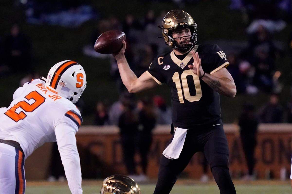 Wake Forest quarterback Sam Hartman (10) throws a pass against Syracuse during the first half of an NCAA college football game in Winston-Salem, N.C., Saturday, Nov. 19, 2022. (AP Photo/Chuck Burton)