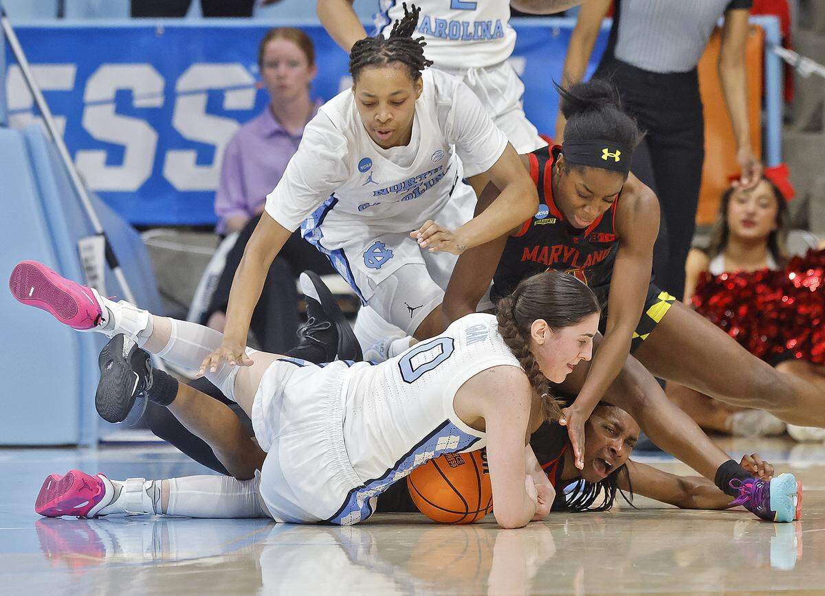 North Carolina’s Lanie Grant dives on a loose ball past Maryland’s Oluchi Okananwa and Mir McLean during the second half of the Tar Heels’ 74-66 second-round NCAA Tournament win over Maryland on Sunday, March 22, 2026, at Carmichael Arena in Chapel Hill, N.C.