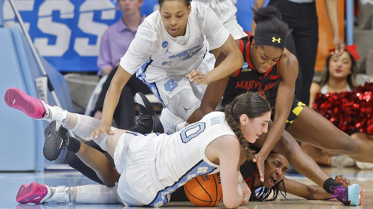 North Carolina’s Lanie Grant dives on a loose ball past Maryland’s Oluchi Okananwa and Mir McLean during the second half of the Tar Heels’ 74-66 second-round NCAA Tournament win over Maryland on Sunday, March 22, 2026, at Carmichael Arena in Chapel Hill, N.C.