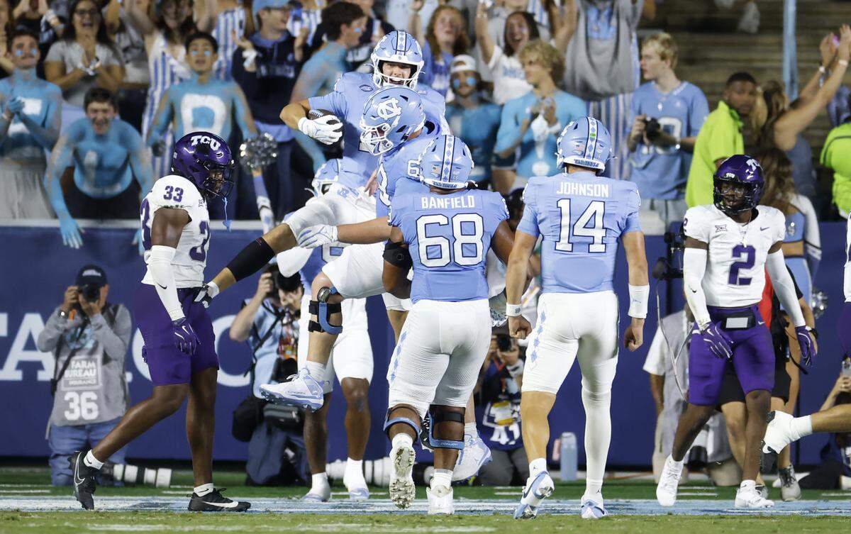 North Carolina’s Jake Johnson (19) celebrates with Chad Lindberg (69) after Johnson pulled in a two-yard touchdown reception from his brother, quarterback Max Johnson (14), during the second half of UNC’s game against TCU at Kenan Stadium in Chapel Hill, N.C., Monday, Sept. 1, 2025.