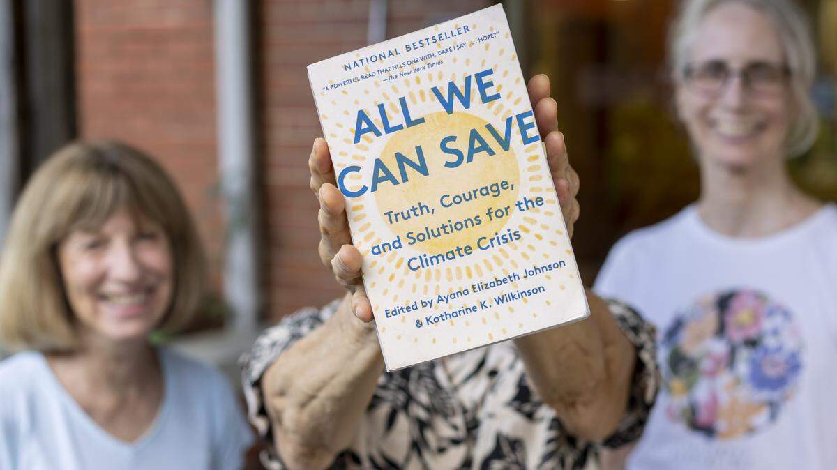 Chatham Climate Action Network members from left, Vickie Atkinson, Betsy Kraus and Lenore Yarger with a copy of “All We Can Save”, the book that inspired their network on Tuesday, July 29, 2025 in Pittsboro, N.C.