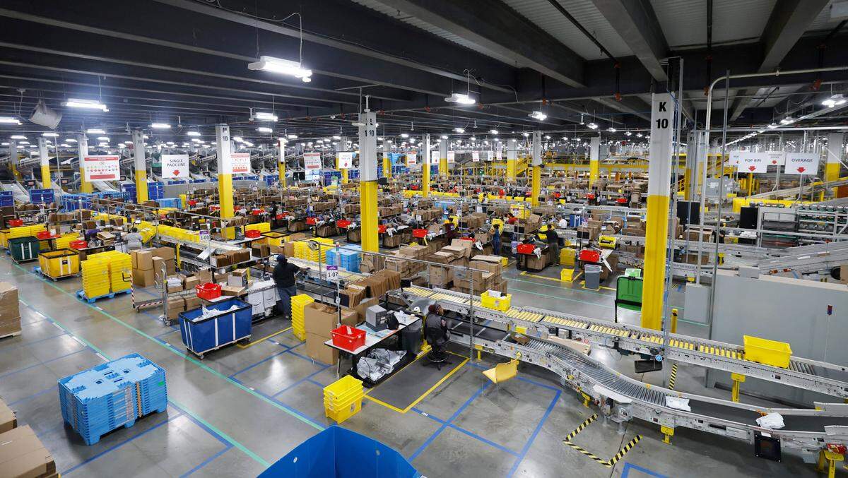 Employees work at RDU1, an Amazon Robotics Fulfillment Center in Garner, N.C., Tuesday, July 1, 2025.