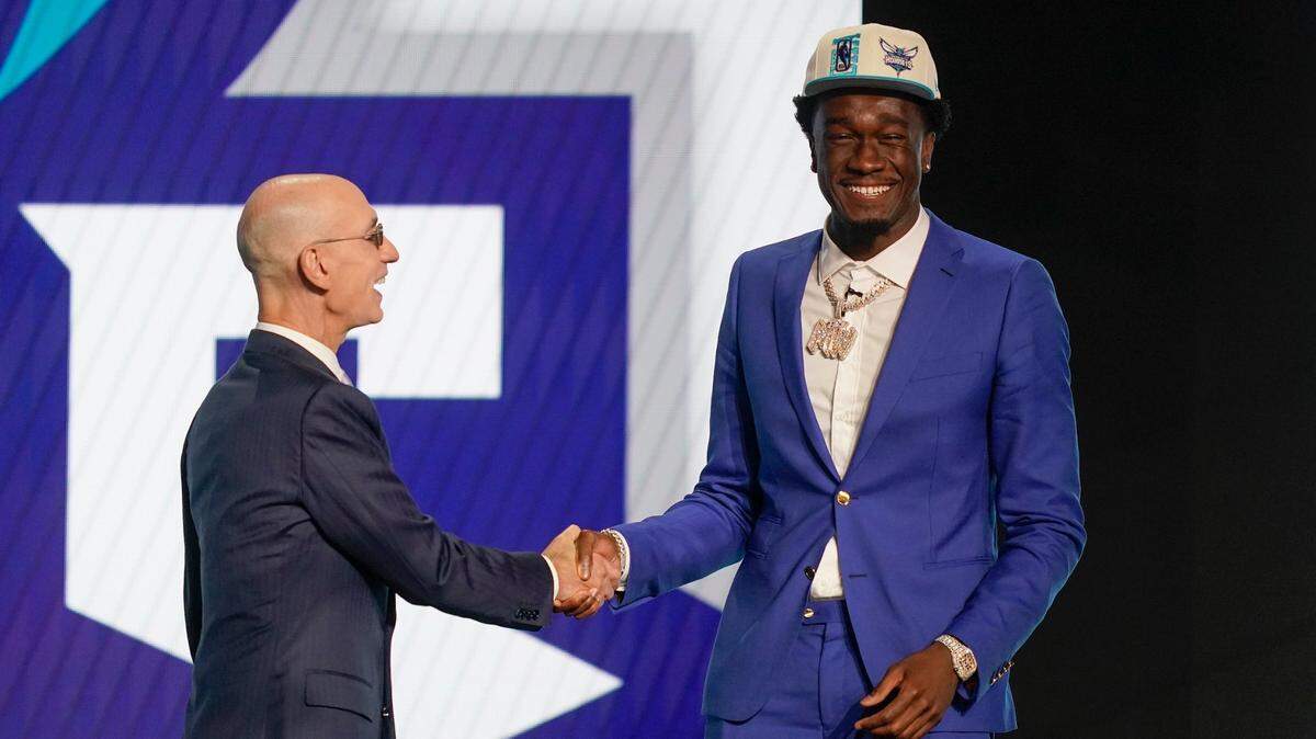 Mark Williams, right, is congratulated by NBA Commissioner Adam Silver after being selected the Charlotte Hornets in the NBA basketball draft, Thursday, June 23, 2022, in New York. (AP Photo/John Minchillo)