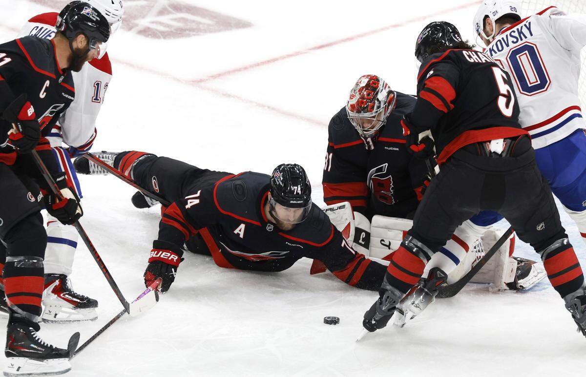 Carolina's Jaccob Slavin (74) and Frederik Andersen (31) keep their eyes on the puck in the first period of the Hurricanes’ game against the Canadiens in game five of the Eastern Conference Finals at the Lenovo Center Friday, May 29, 2026.