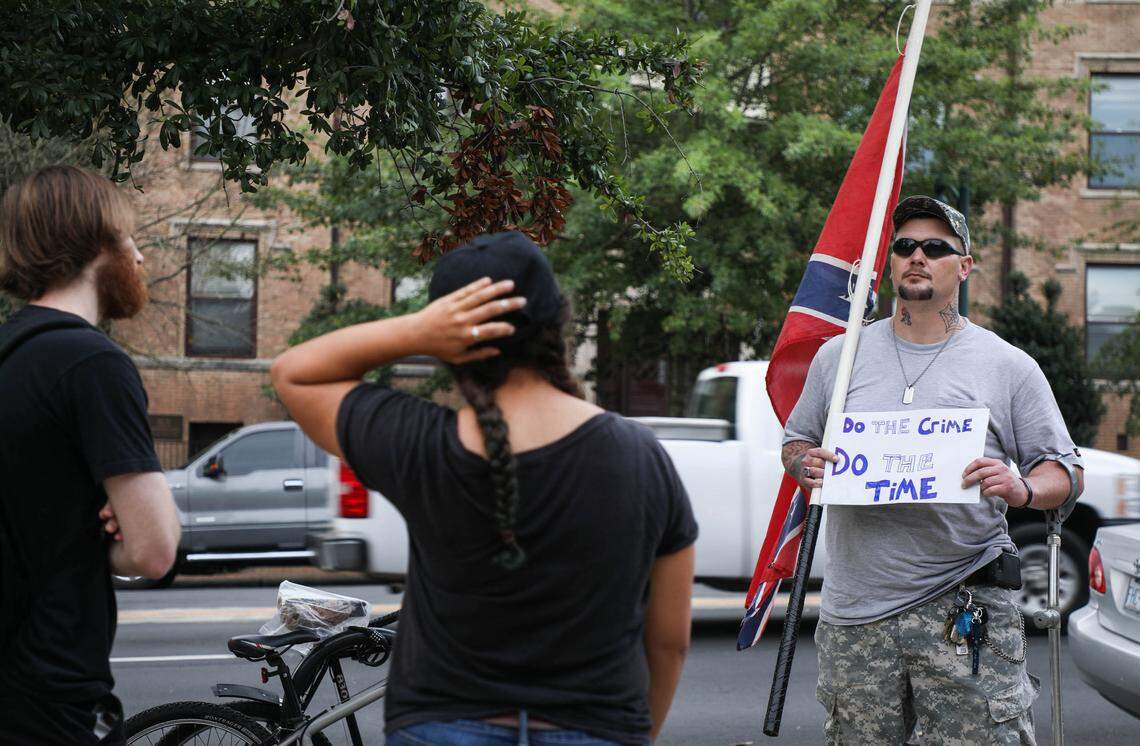 A pro-Silent Sam demonstrator waits outside the Chapel Hill Courthouse as supporters of those arrested in relation to demonstrations on UNC’s campus had breakfast before supporting the 11 defendants on Tuesday, Oct. 9, 2018.