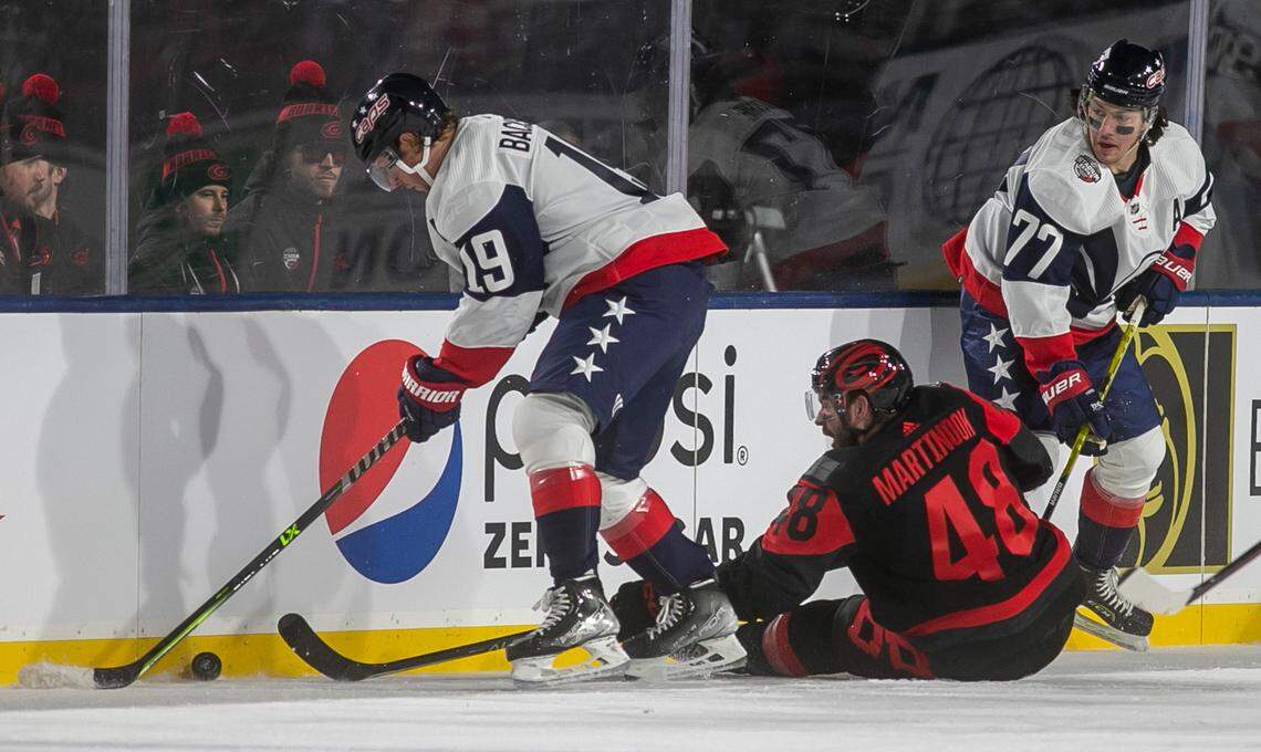 Carolina Hurricanes’ Jordan Martinook (48) goes after the puck under Washington Capitals’ Nicklas Backstroke (19) in the first period during the Stadium Series game on Saturday, February 18, 2022 at Carter-Finley Stadium in Raleigh, N.C.