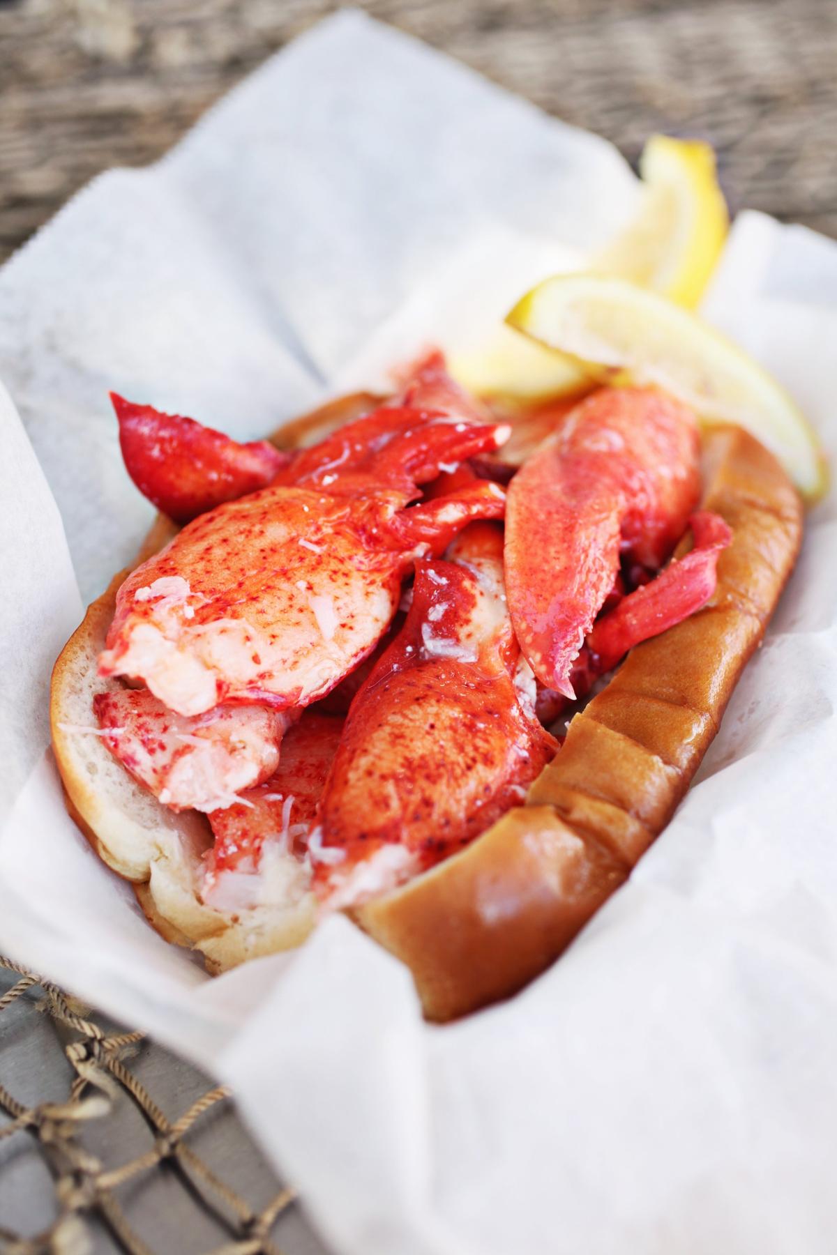 The classic Maine lobster roll from Cousins Maine Lobster delivers chunks of chilled sweet lobster meat in such abundance that you can barely see the buttered and toasted New England style top-split hot dog roll it’s served on.