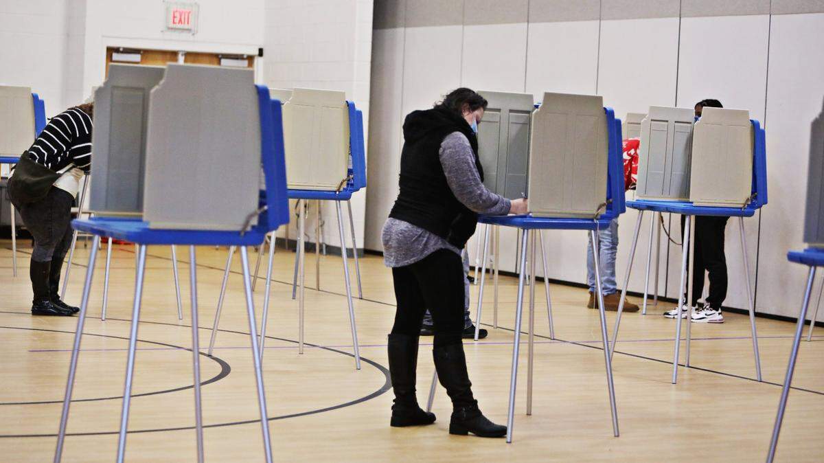 Voters are spaced out in the gym at Banks Road Elementary in Fuquay-Varina Tuesday morning, Nov. 3, 2020.