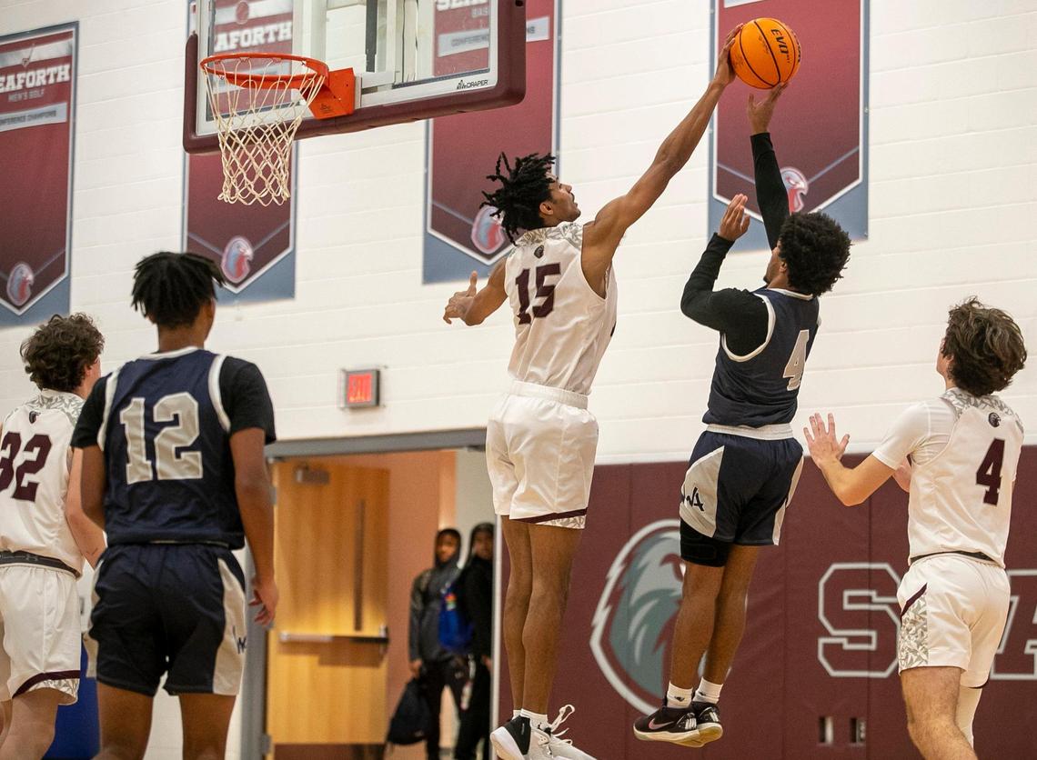 Seaforth High School’s Jarin Stevenson (15) blocks a shot by Western Alamance’s Camron Daye (4) during a non-conference game on Thursday, December 8, 2022 in Pittsboro, N.C. Seaforth defeated Western Alamance 46-28.