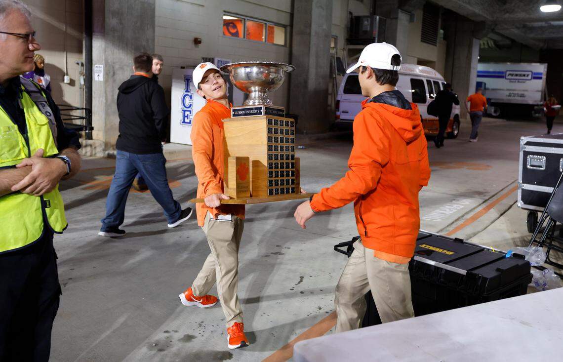 Clemson personnel take the Textile Bowl trophy from N.C. State after Clemson’s 30-20 victory over the Wolfpack at Memorial Stadium in Clemson, S.C., Saturday, Oct. 1, 2022.