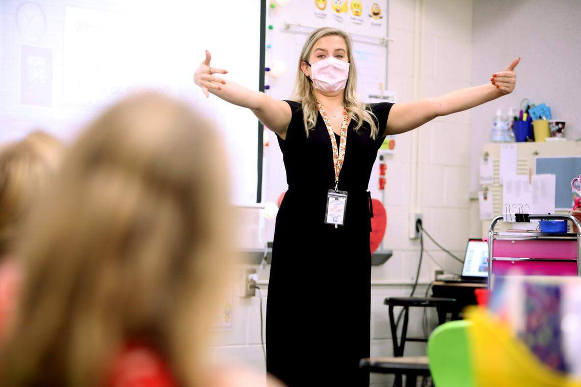 Hunter Elementary School first-grade teacher Alyssa Housman demonstrates how to give an air hug to her class on Monday, October 26, 2020, on the first day back in school for some Wake students.