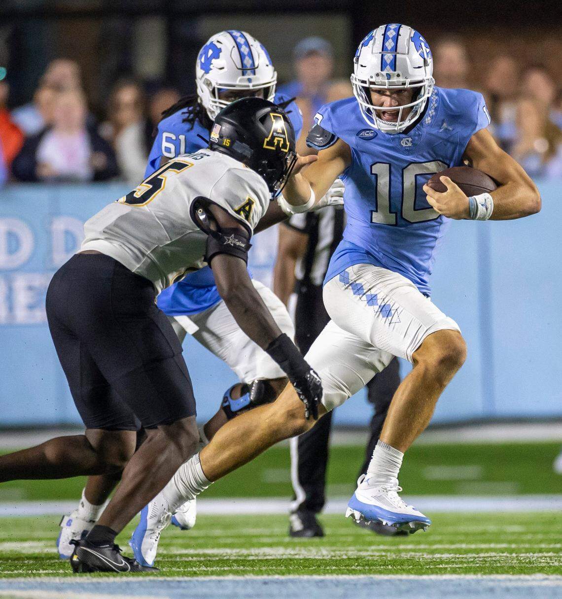 Appalachian State’s Thomas Davis (15) works to stop North Carolina quarterback Drake Maye (10) after a 12-yard gain in the final minute of play on Saturday September 9, 2023 at Kenan Stadium in Chapel Hill, N.C.