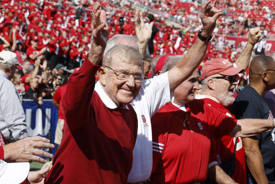 Former N.C. State coach Lou Holtz and the 1973 ACC championship team acknowledge the crowd during the first half of N.C. State’s game against Marshall at Carter-Finley Stadium in Raleigh, N.C., Saturday, Oct. 7, 2023.