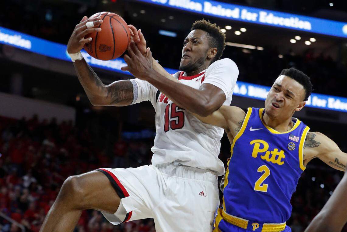 N.C. State’s Manny Bates (15) pulls in the rebound from Pittsburgh’s Trey McGowens (2) during the second half of the Wolfpack’s 77-73 victory over the Pittsburgh Panthers at PNC Arena in Raleigh, N.C., Saturday, Feb. 29, 2020.