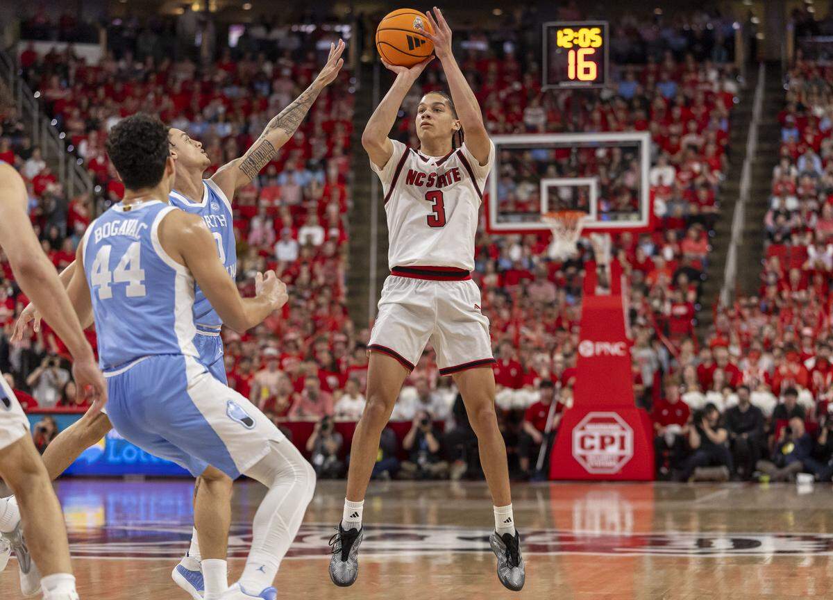 N.C. State forward Matt Able (3) makes a three-point basket to give the Wolfpack an 11 point lead early in the first half against North Carolina on Tuesday, February 17, 2026 at Lenovo Center in Raleigh, N.C.