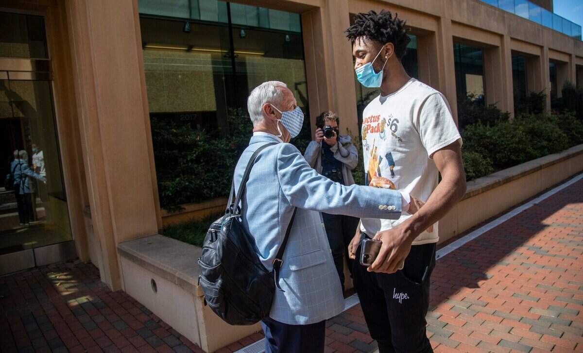 Carolina basketball player Leaky Black greets mens basketball coach Roy Williams at the Dean Smith Center at UNC-Chapel Hill prior to a press conference. Williams announced his retirement Thursday, April 1, 2021.