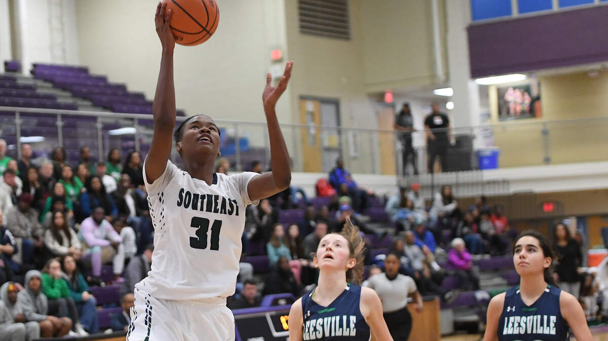 Anya Poole (31) of Southeast scores a basket against Lucy Leen (25) and Lola Jacobs (20) of Leesville Road . The Leesville Road Pride played the Southeast Raleigh Bulldogs in a high school women basketball game on February 22, 2019.