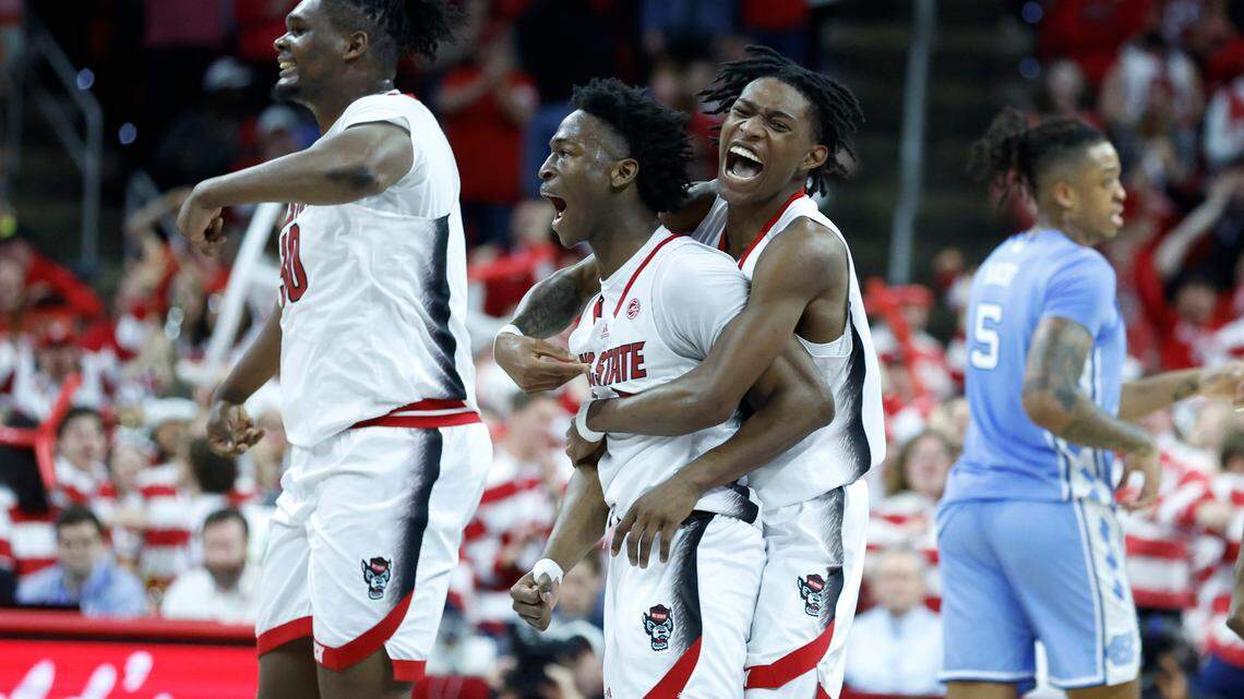 N.C. State’s Terquavion Smith (0) celebrates with Jarkel Joiner (1) after Joiner hit a three-pointer to put the Wolfpack up 67-60 during the second half of N.C. State’s 77-69 victory over UNC at PNC Arena in Raleigh, N.C., Sunday, Feb. 19, 2023.
