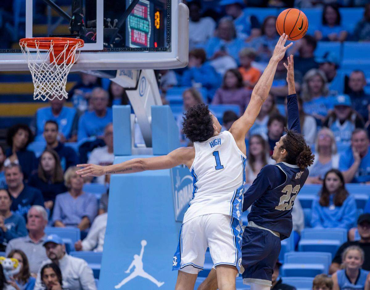 North Carolina’s Zayden High (1) blocks a set by St Augustine’s Jefferson Youngblood (22) in the second half on Friday, October 27, 2023 at the Smith Center in Chapel Hill, N.C.