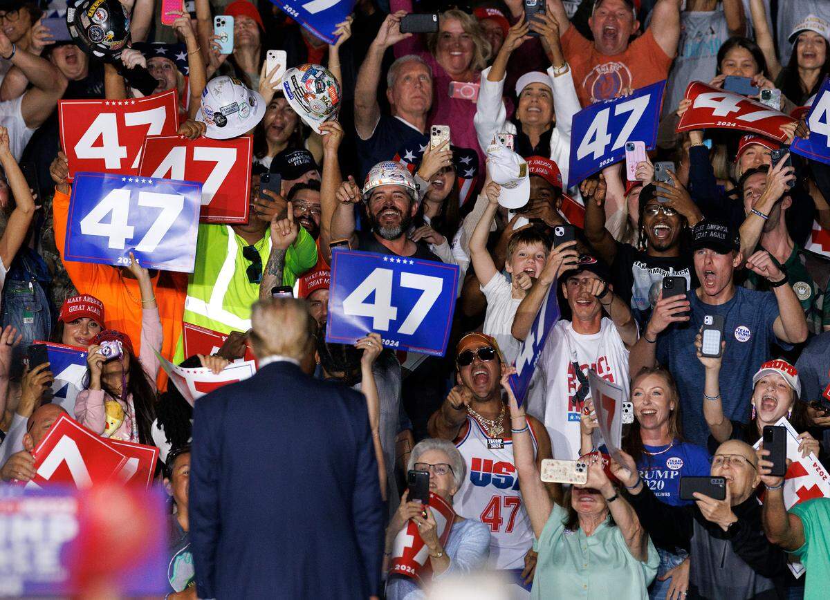 Supporters acknowledge former President and Republican presidential candidate Donald Trump at the conclusion of a rally at the Greensboro Coliseum Complex on Tuesday, Oct. 22, 2024, in Greensboro, N.C.