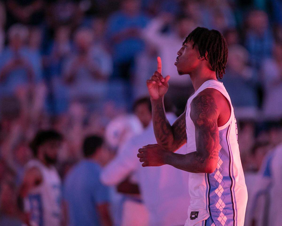 North Carolina’s Caleb Love (2) says a prayers prior to the tip off against College of Charleston on Friday, November 11, 2022 at the Smith Center in Chapel Hill, N.C.