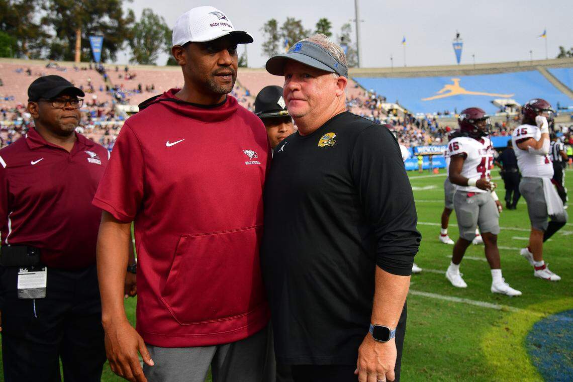 UCLA Bruins head coach Chip Kelly meets with North Carolina Central Eagles head coach Trei Oliver following the victory at Rose Bowl.