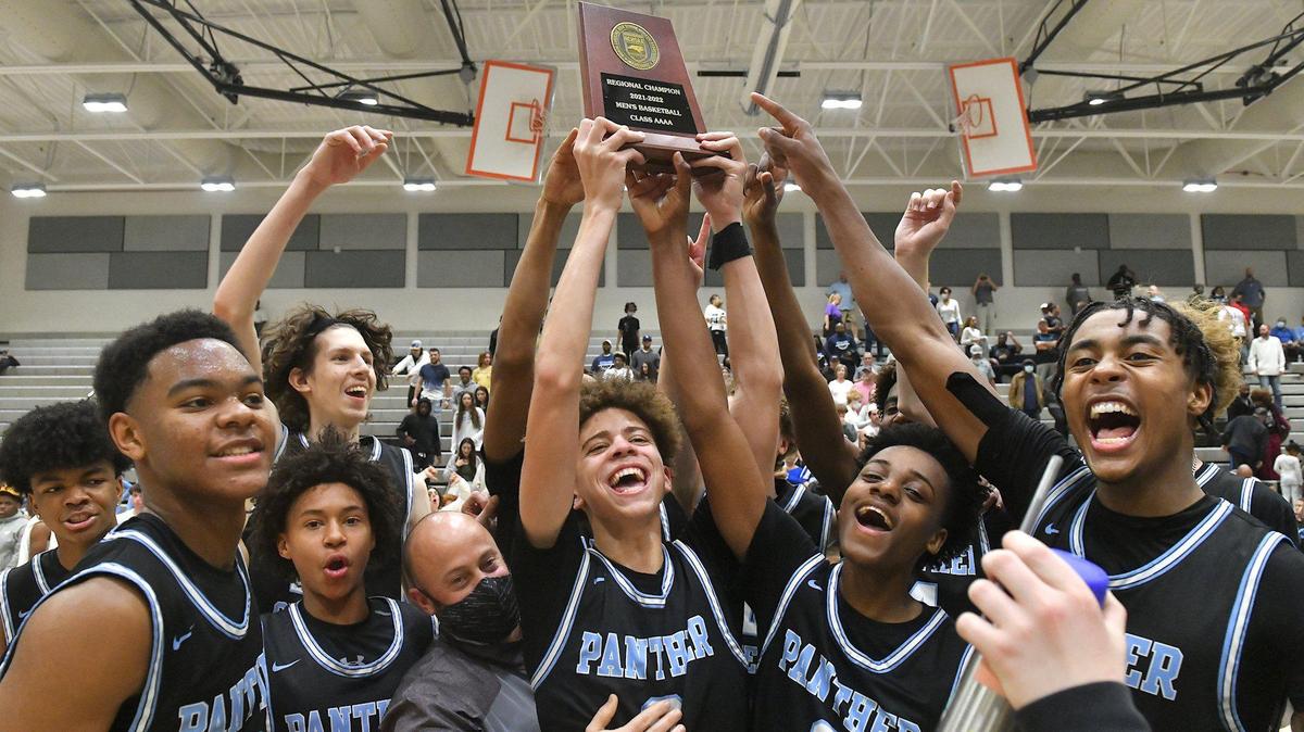 Panther Creek’s Jordan Snell (0) hoists up the East Regional Trophy and celebrates with his team after their defeat of Cleveland in the 4A Eastern Regional Final. The Panther Creek Catamounts and the Cleveland Rams met in the NCHSAA 4A Boys East Regional Finals in Cary, N.C. on March 5, 2022.