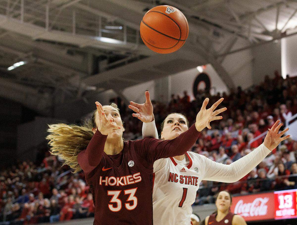 Virginia Tech’s Elizabeth Kitley and N.C. State’s River Baldwin battle for a rebound during the first half of the Wolfpack’s game on Thursday, Feb. 8, 2024, at Reynolds Coliseum in Raleigh, N.C.