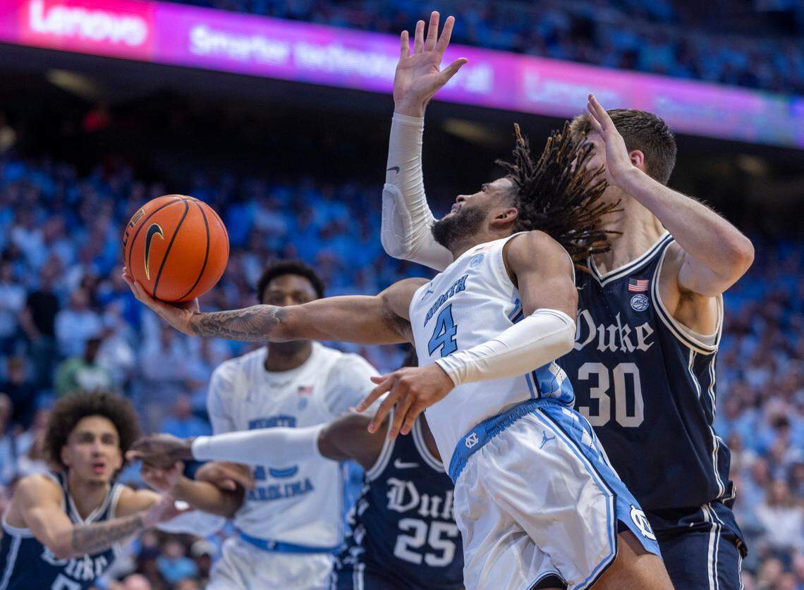 North Carolina’s R.J. Davis (4) breaks to the basket past Duke’s Kyle Filipowski (30) in the second half on Saturday, February, 3, 2024 at the Dean E. Smith Center in Chapel Hill, N.C.