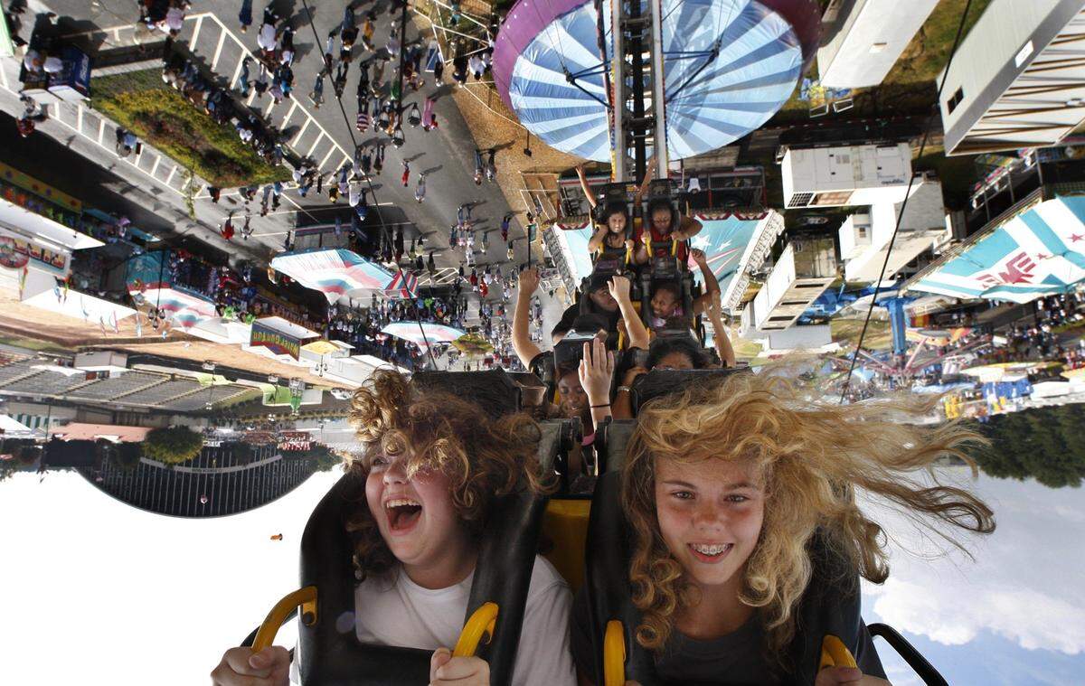 Courtney Stegall,12, left and pal Scarlett Harris,13 ride the Ring of Fire at the North Carolina State Fair Thursday Oct.18, 2007. The girls were visiting the fair from Cornerstone Christian School in Roanoke Rapids. Morning showers made way for a hot steamy afternoon the sixth day of the fair.