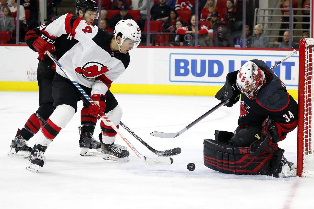 New Jersey Devils’ Miles Wood (44) has his shot turned away by Carolina Hurricanes goaltender Petr Mrazek (34), of the Czech Republic, during the third period of an NHL hockey game in Raleigh, N.C., Friday, Feb. 14, 2020. (AP Photo/Karl B DeBlaker)