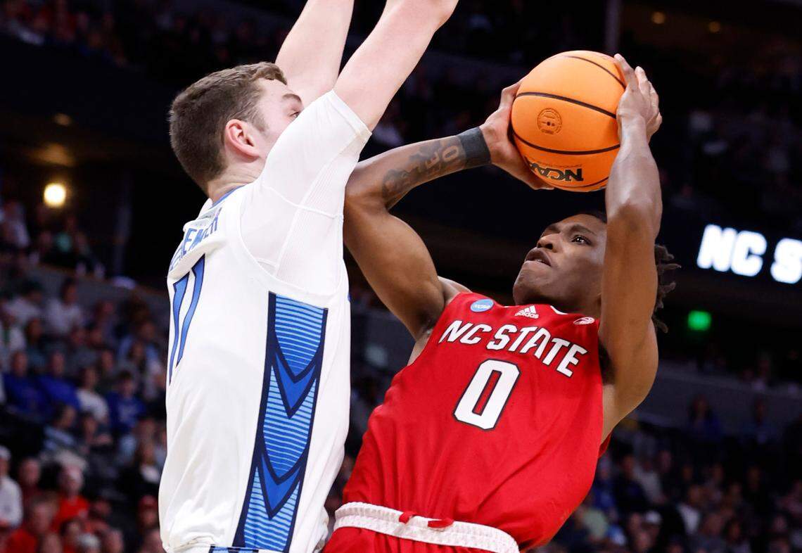 N.C. State’s Terquavion Smith (0) shoots as Creighton’s Ryan Kalkbrenner (11) defends during the first half of N.C. State’s game against Creighton in the first round of the NCAA Tournament at Ball Arena in Denver, Colo., Friday, March 17, 2023.