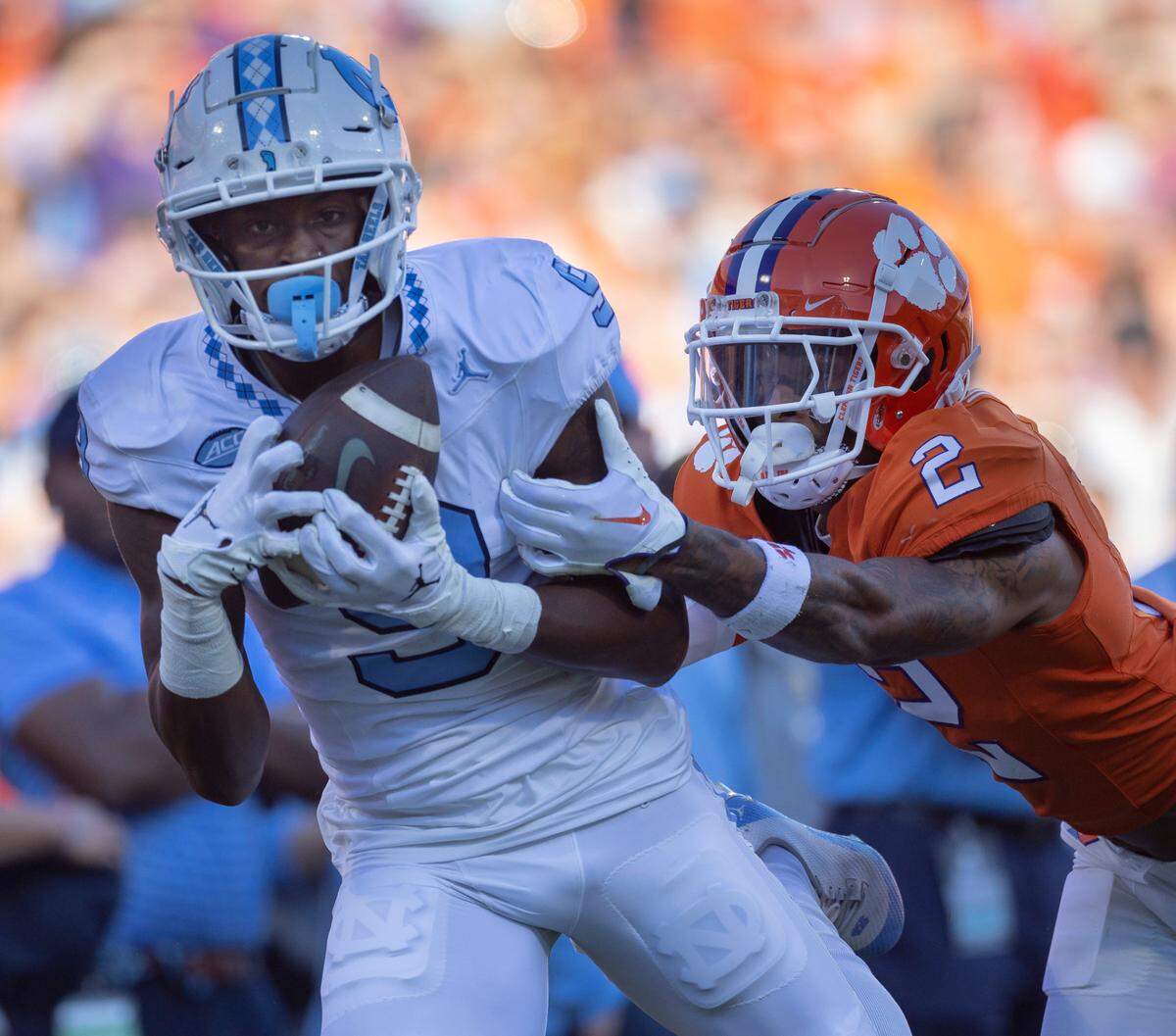 North Carolina’s Devontez Walker (9) pulls in a 43-yard pass completion from quarterback Drake Maye ahead of Clemson’s Nate Wiggins (2) in the first quarter on Saturday, November 18, 2023 at Memorial Stadium in Clemson, S.C.