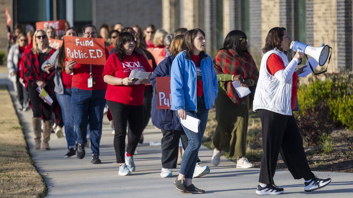 Educators and parents picket outside Fuquay-Varina Elementary School on Thursday, March 19, 2026, during a demonstration organized by the Wake County affiliate of the North Carolina Association of Educators. Protesters urged Wake County school leaders to prevent budget cuts that would reduce spending on special education programs.
