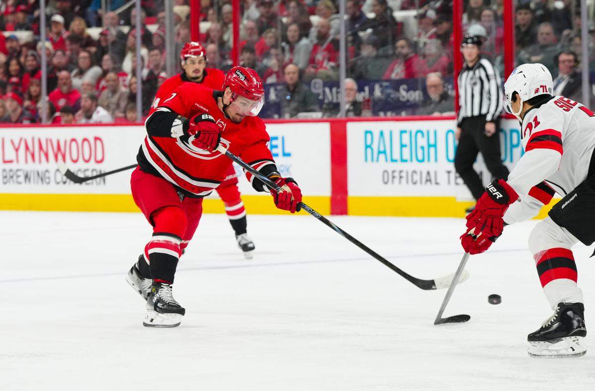 Carolina Hurricanes defenseman Dmitry Orlov (7) shoots against the New Jersey Devils during the first period at Lenovo Center.