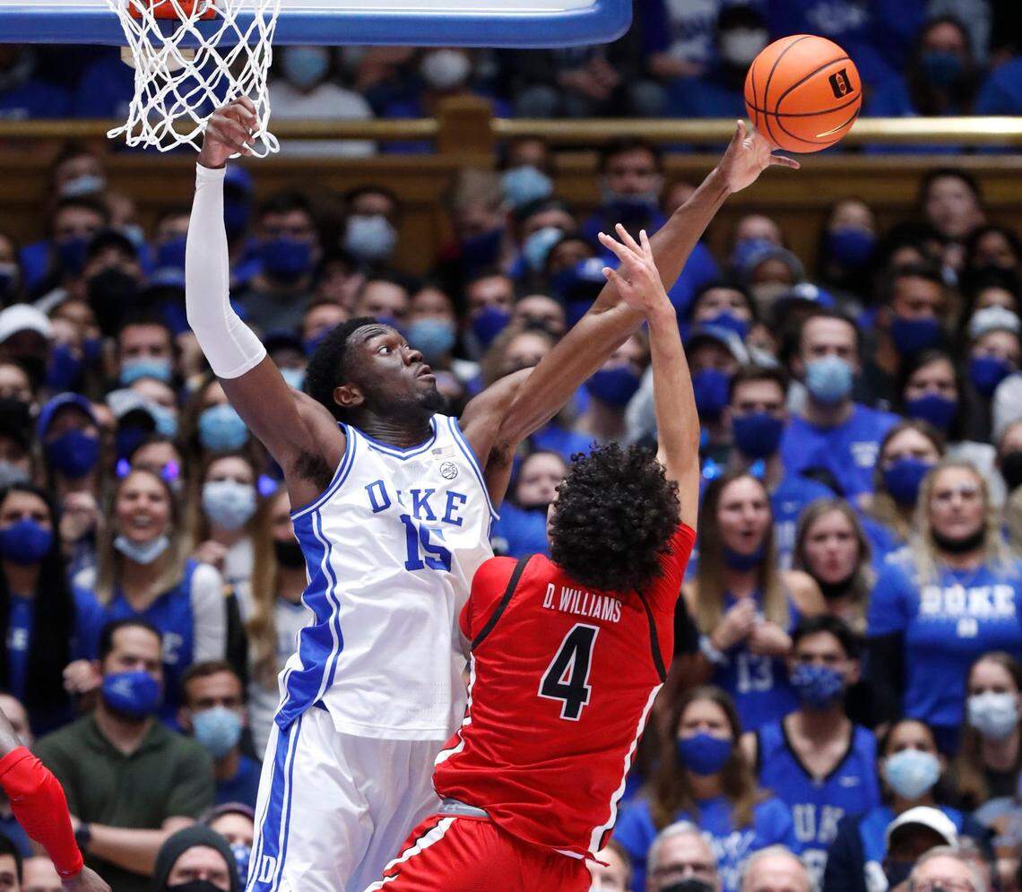 Dukes Mark Williams (15) blocks the shot by Gardner-Webb’s D’Maurian Williams (4) during the first half of Dukes game against Gardner-Webb at Cameron Indoor Stadium in Durham, N.C., Tuesday, November 16, 2021.