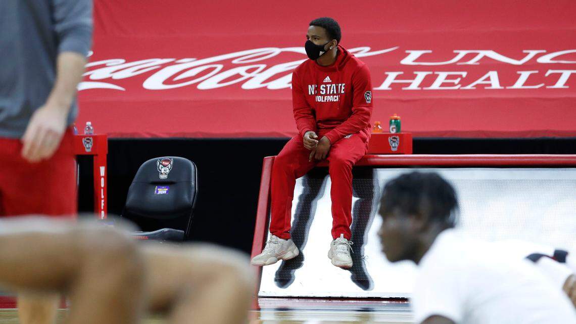 N.C. State’s Thomas Allen watches the team warm up before N.C. State’s game against Pittsburgh at PNC Arena in Raleigh, N.C., Sunday, February 28, 2021.