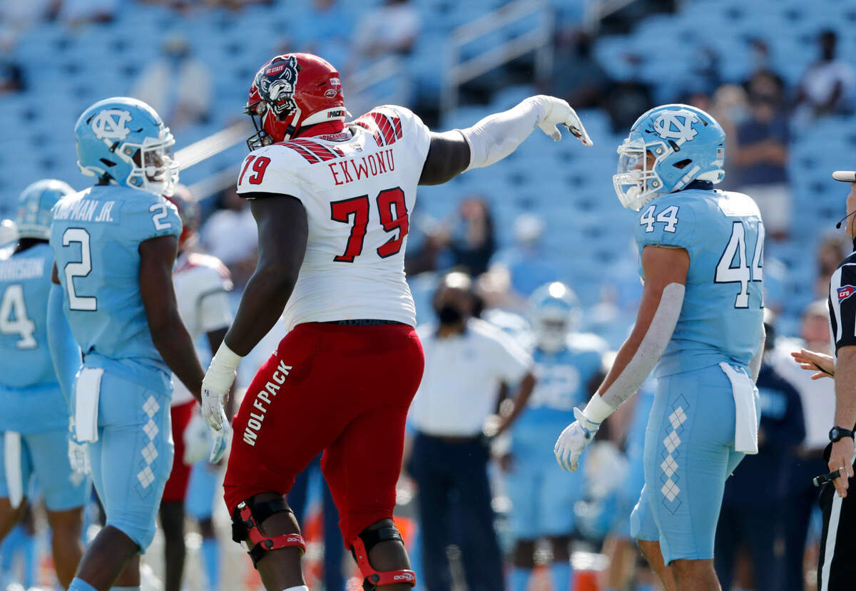 N.C. State offensive lineman Ikem Ekwonu (79) waves bye to North Carolina linebacker Jeremiah Gemmel (44) after a little jawing after the play during the first half of N.C. State’s game against UNC at Kenan Stadium in Chapel Hill, N.C., Saturday, Oct. 24, 2020.