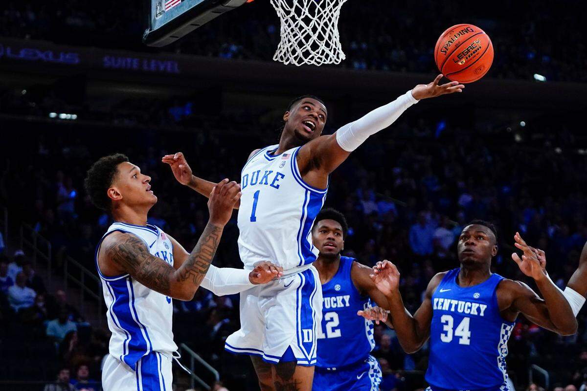 Duke’s Trevor Keels (1) fights for control of the ball as Duke’s Bates Jones (34) watches during the first half of an NCAA college basketball game Tuesday, Nov. 9, 2021, in New York.