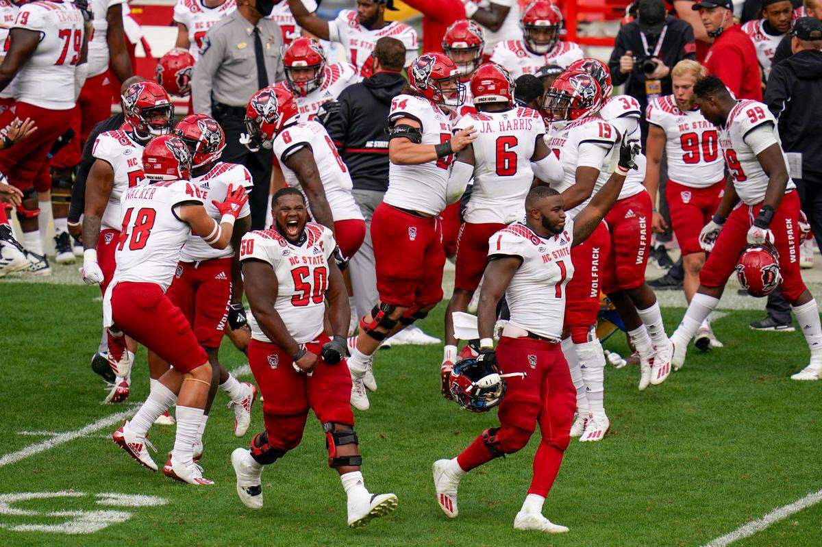 The North Carolina State defense celebrates as time runs out, defeating the No. 24 Pittsburgh in an NCAA college football game, Saturday, Oct. 3, 2020, in Pittsburgh. North Carolina State won 30-29.